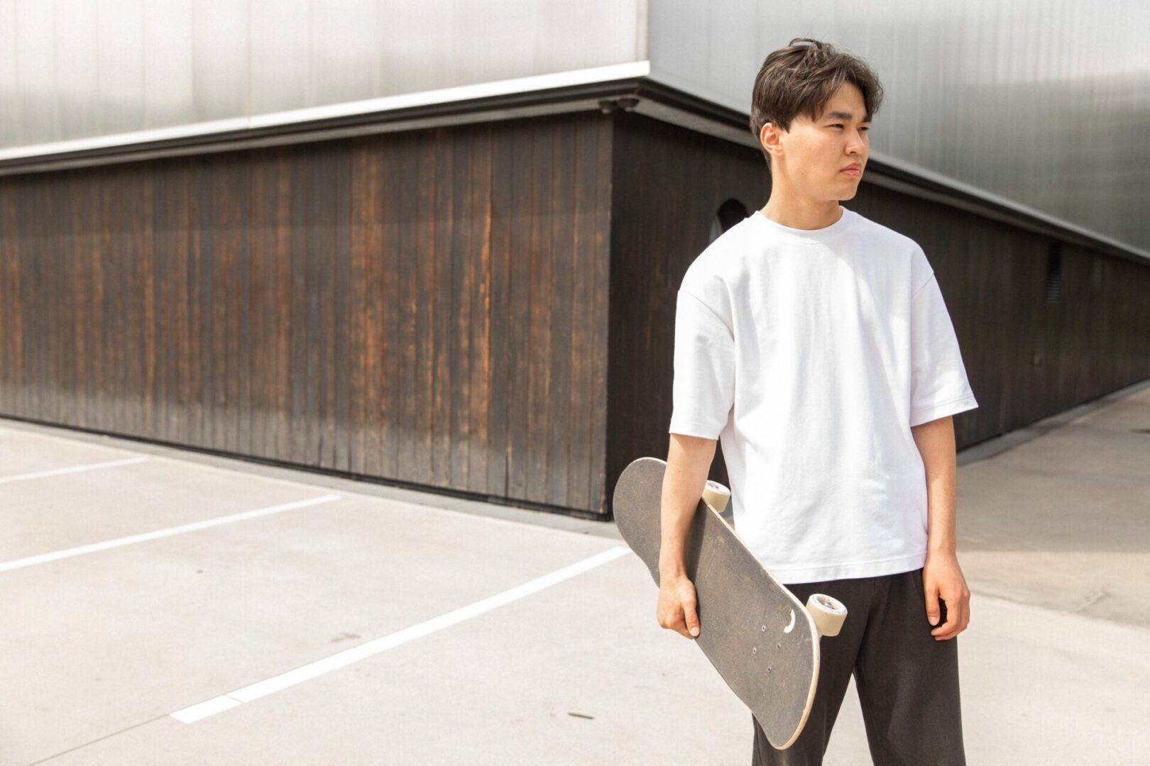 A man holding a skateboard in his hand.